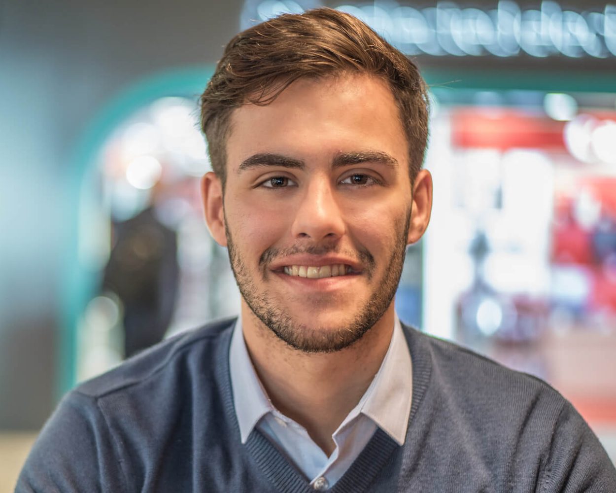 portrait-close-up-of-young-man-smiling-2021-08-29-09-15-04-utc